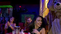 Insatiable milfs suck on stripper's dick in a club in reality video