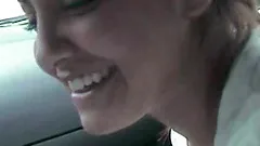 Nasty brown-haired chick gives a blowjob to her BF in a car