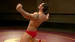Two oiled up dudes are going to have a wild wrestling