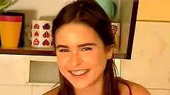 Slim teen Veronika enjoys fingering her pussy in the kitchen