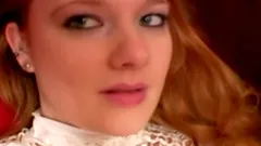 Redhead siren Meaghan is poking herself with a toy