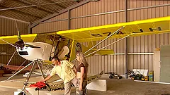 Two salacious brunettes share a hard cock on a beach