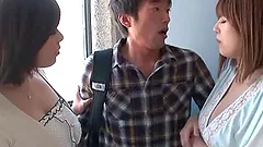 Two busty Japanese milfs share a cock in the living room