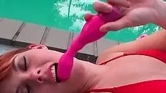 Teenage hot redhead toying her cunt at the pool