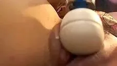 Curly haired brunette uses vibrator