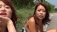 Two busty milfs give a titjob to some lucky dude in a car