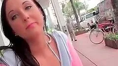 Brunette tempting girl shows her big tits in public