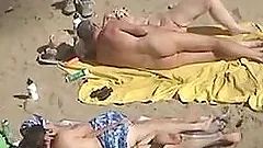 Girl gets her pussy fingered by her husband on a nude beach