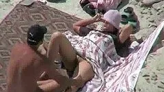 Horny dude fucks his sleeping wife on a beach. Spy cam clip