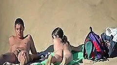 Pretty brunette plays with her BF's big cock on a beach