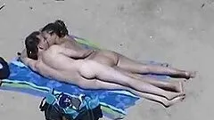 Pretty girl favours her BF with a hot handjob on a beach