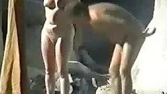 Mature blonde gives a blowjob to her husband on a beach