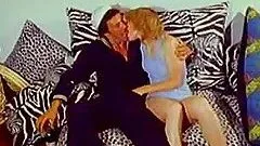 Slutty redhead milf enjoys riding a cock in retro clip