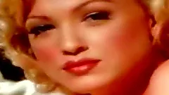 Beautiful Marilyn Forever lies on a bed and poses naked