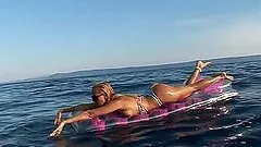 Slutty blonde Sandy plays with her pussy while swimming in a lake