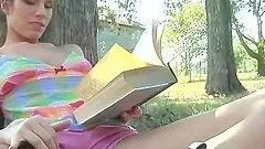 Cute Bree Morgan reads a book and shows her naked body in the park