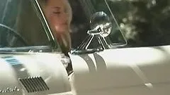 Monica Paige poses naked standing in cabriolet