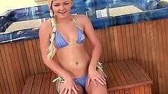 Sexy blonde girl toys herself standing back to camera