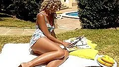 Curly blonde girl toys her pussy with a banana in the backyard