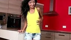 Stunning brunette toys herself on the kitchen table