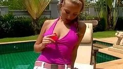Slutty girl toys her tight ass with a dildo by the pool