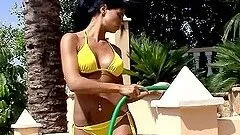 Smoking hot brunette waters her naked body and acts naughty