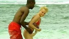 Interracial Couple Having Fun Outdoors On The Beach