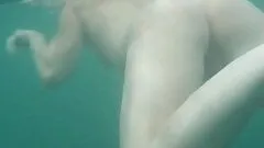 Underwater Voyeur Cam Catches a Sensual Babe Swimming Naked On a Beach