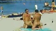 Two Guys and One Sexy Babe Have a Hot Threesome on a Nude Beach
