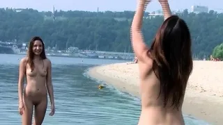 Sensual nude beach girl relaxes outdoors in the sun.