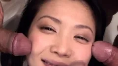 Asian bimbo sucks on a big cock close up