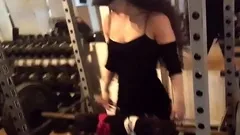 Fit babe working out at a gym with heavy weights