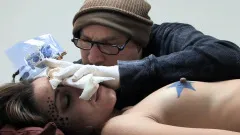 Amina Sky gets a face tattoo while completely nude