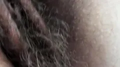 Hairy mature flashing in front of window