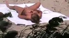 voyeur catches MILF on a beach