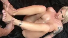 Big breasted tattooed blonde has a kinky guy licking her lovely feet