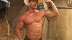 Beefy cowboy flexes and whips out his cock to give it a few strokes