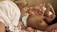 Two fascinating young lesbians drive each other's wet pussies to orgasm on the bed