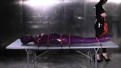 Freaky lesbian mistress with a latex fetish immobilizes her pet