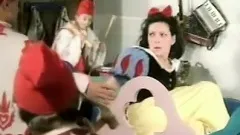 Snow White plays with a thick long candle for her seven dwarves