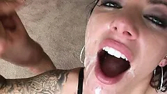 Gorgeous tattooed brunette gets her pretty face covered with hot jizz