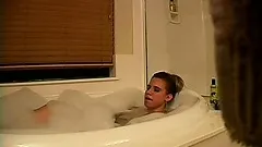 Amanda enjoys a relaxing and soothing bubble bath and plays with her fiery cunt
