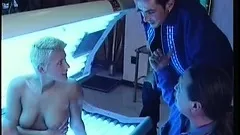 Blonde in a tanning booth gets a stick to eat and gets fucked inside