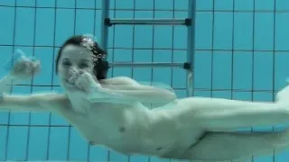 Podvodkova swimming in blue bikini in the pool