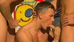 Buff biker boys park the motorcycle in the alley and use it to have a threesome on