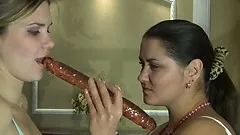 Busty brunette cougar and sultry blonde teen please each other with a red dildo