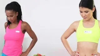 Brunette fingers ebony babe at the gym