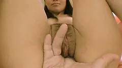 Naughty japanese babe smiles for the camera while getting fingered