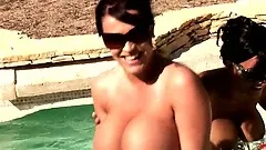 Two luscious goddesses with massive racks take a dip in the pool