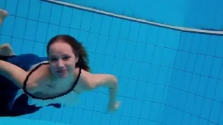 Teen girl Avenna is swimming in the pool